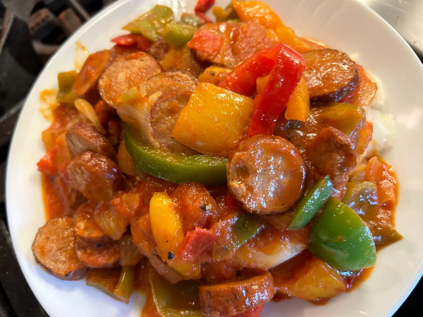 Sliced kielbasa with red, yellow, and green peppers in house letcho sauce served over mashed potatoes at Kat’s Café & Restaurant.