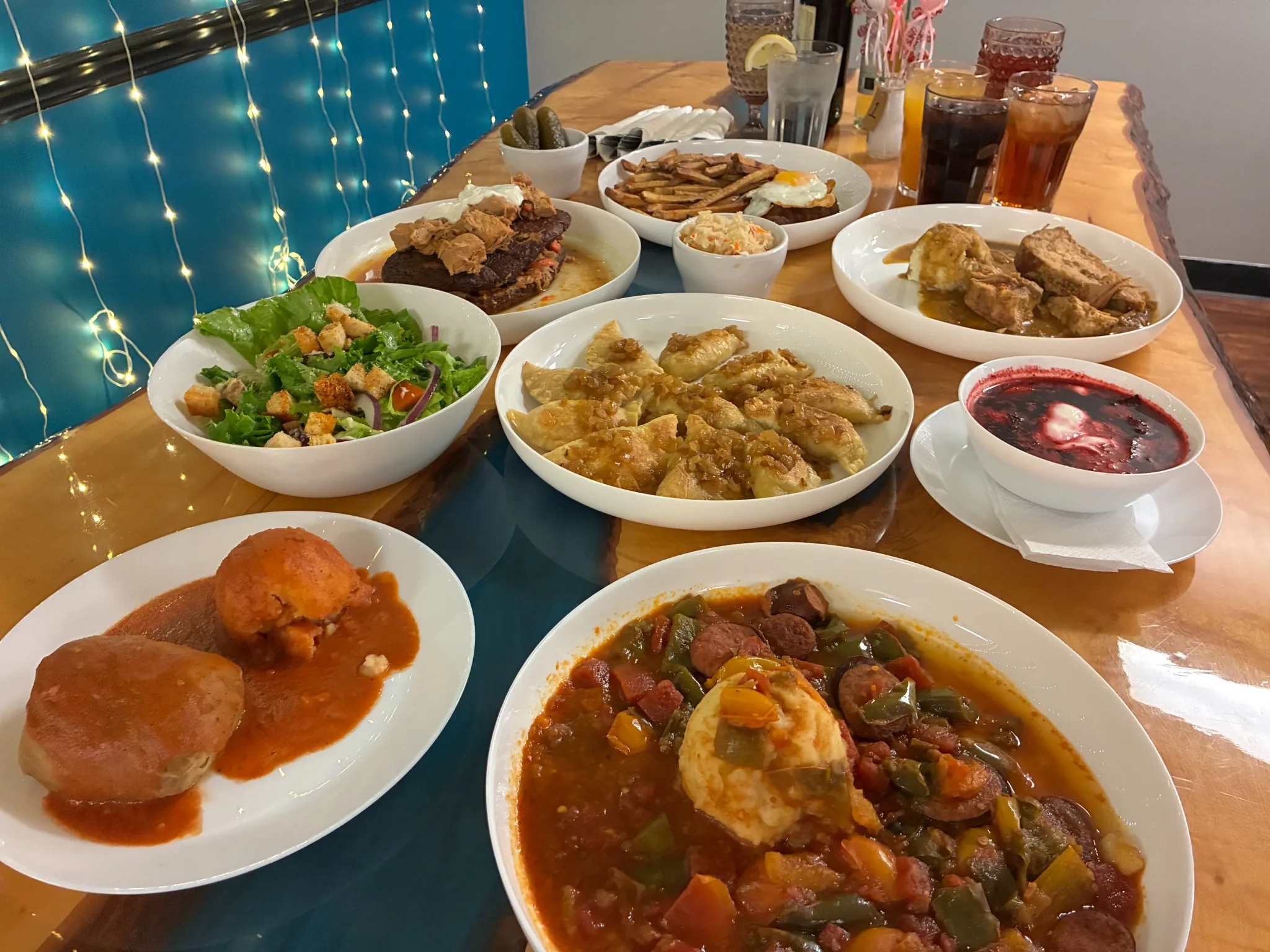 Table spread at Kat’s Café & Restaurant with handmade pierogies, red beet borscht, letcho kielbasa over mashed potatoes, halupki, salad, fries, and homestyle meat dishes.
