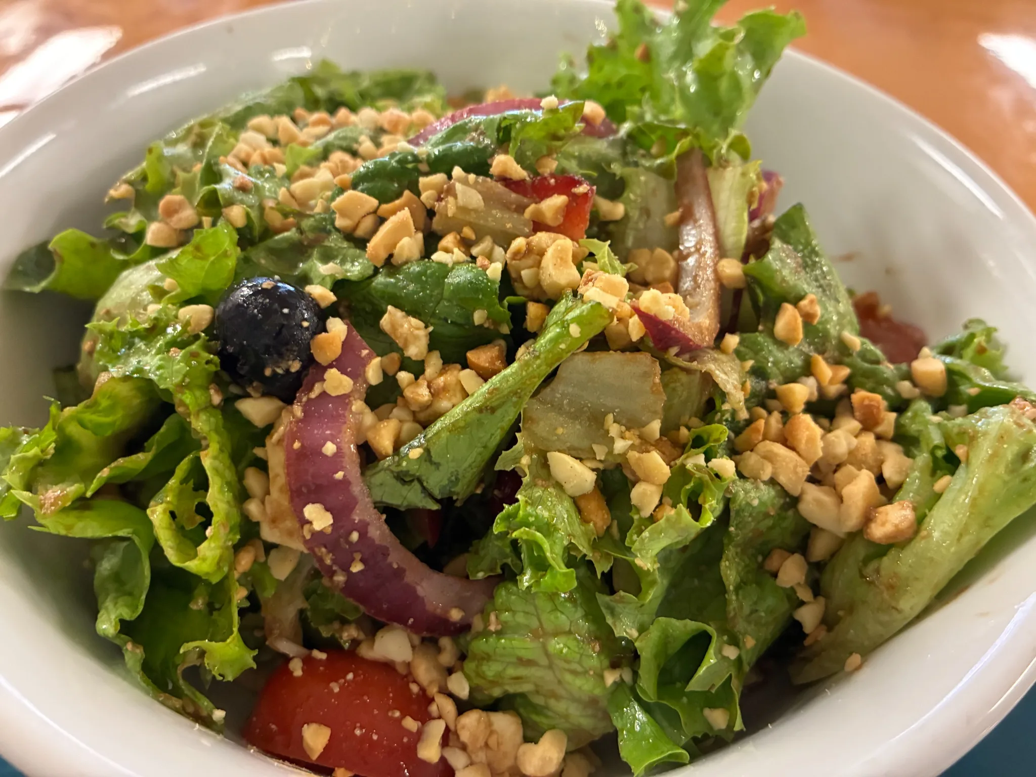 Mixed green salad with lettuce, tomato, red onion, blueberries, and chopped nuts at Kat’s Café & Restaurant.