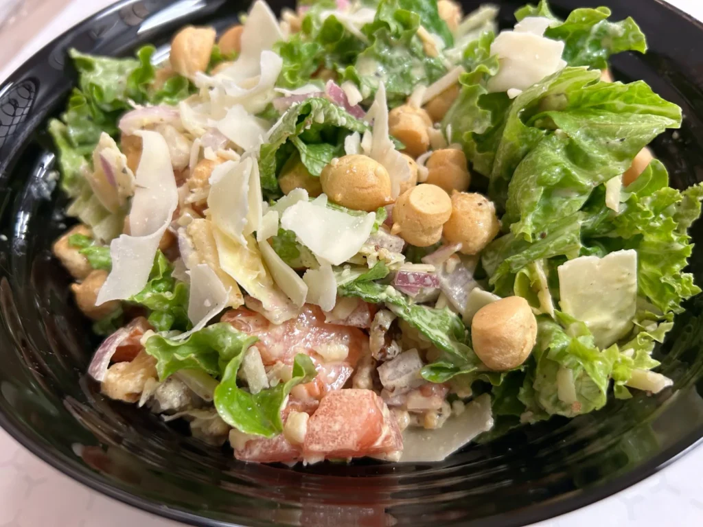 House salad with lettuce, tomato, red onion, Parmesan shavings, and puffy gourmet crouton toppings at Kat’s Café & Restaurant.