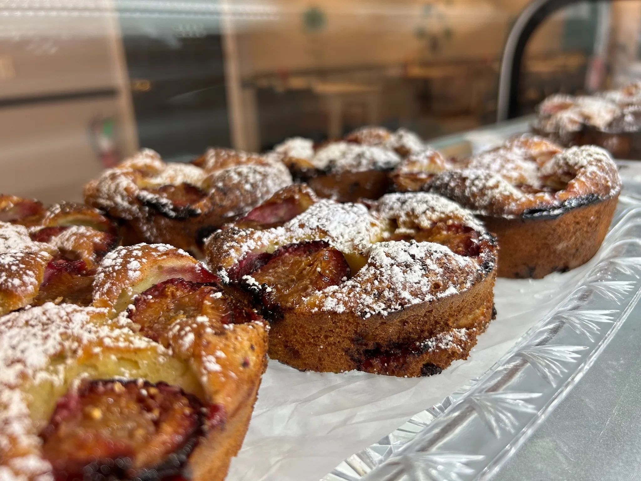 Mini plum cakes dusted with powdered sugar on a crystal tray at Kat’s Café & Restaurant.