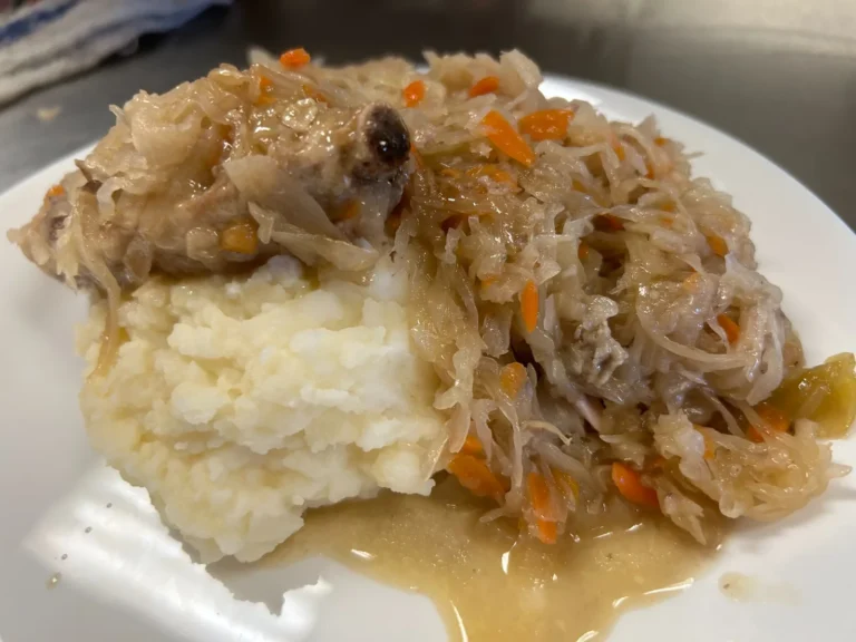 Close-up of tender pork and sauerkraut with carrots served over mashed potatoes at Kat’s Café & Restaurant.