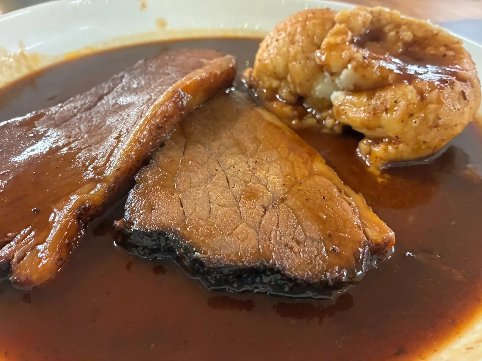 Thick slices of smoked brisket covered in homemade bbq gravy and served with a hearty potato side at Kat’s Café & Restaurant.
