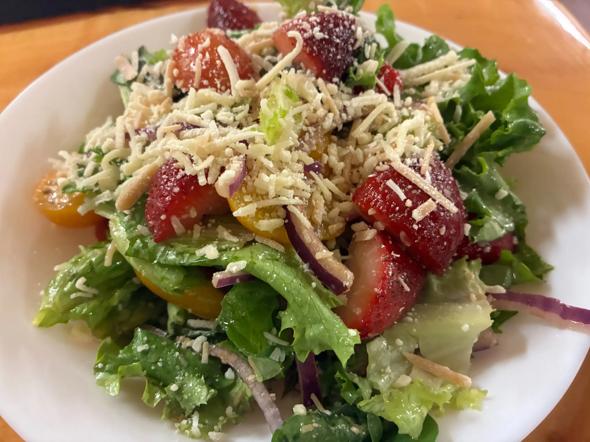 Fresh salad with strawberries, tomatoes, red onion, lettuce, and grated Parmesan at Kat’s Café & Restaurant.