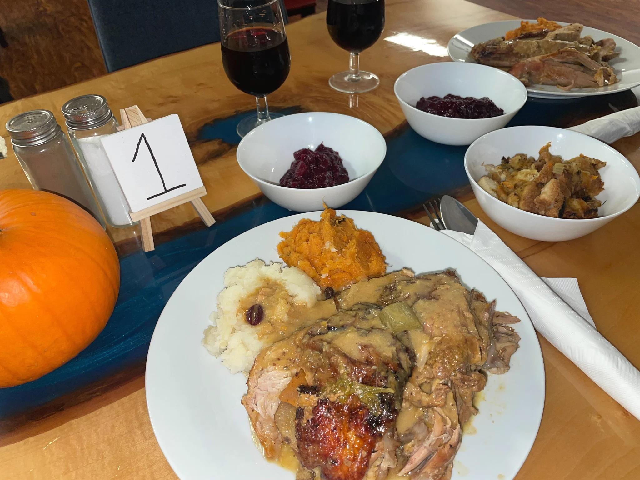 Thanksgiving dinner spread for two at Kat’s Café & Restaurant with roast turkey, mashed potatoes, sweet potatoes, yams, stuffing, cranberry sauce, and wine.
