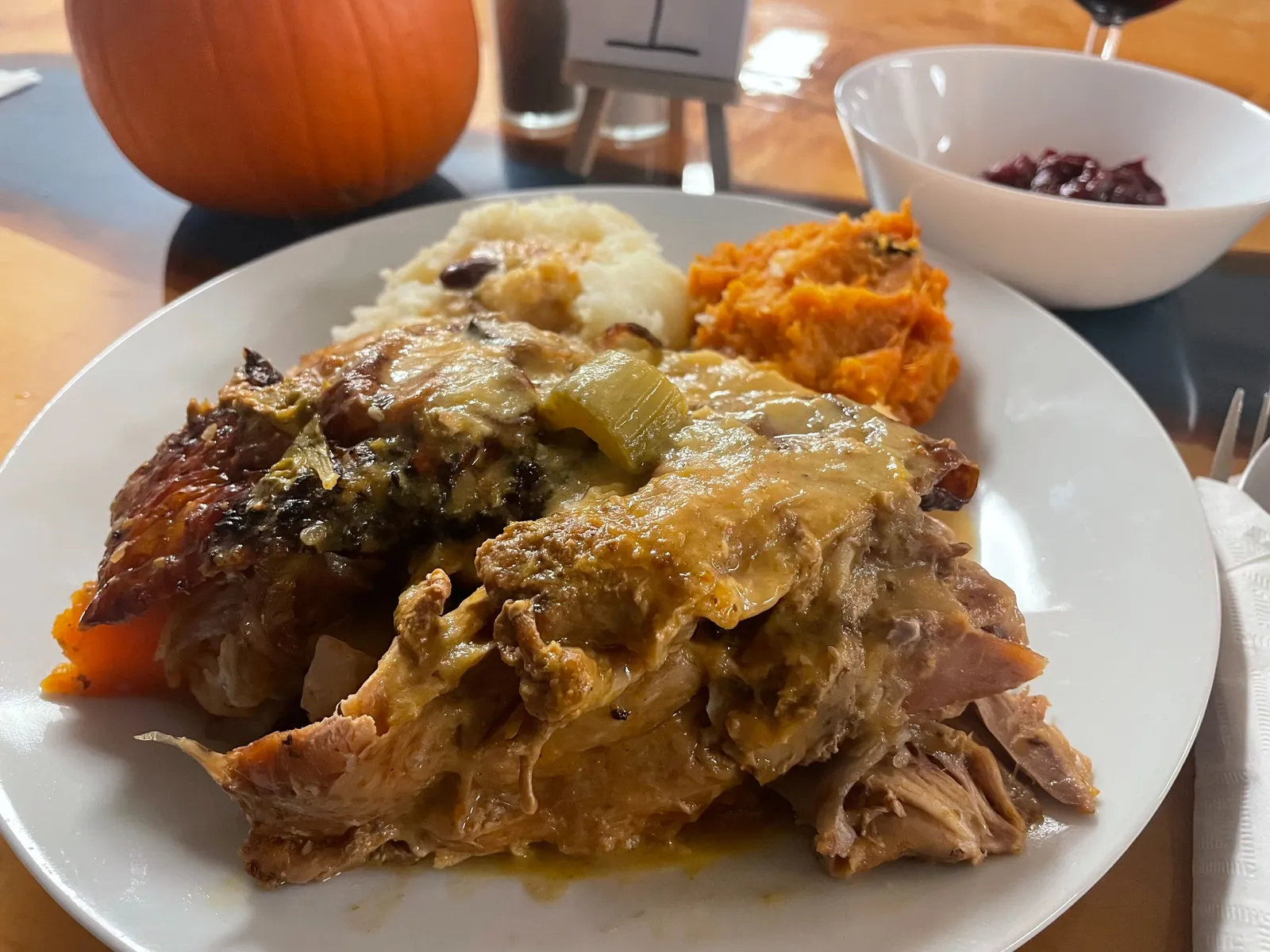 Roast turkey with house gravy, mashed potatoes, sweet potatoes, and cranberry sauce on a white plate at Kat’s Café & Restaurant.