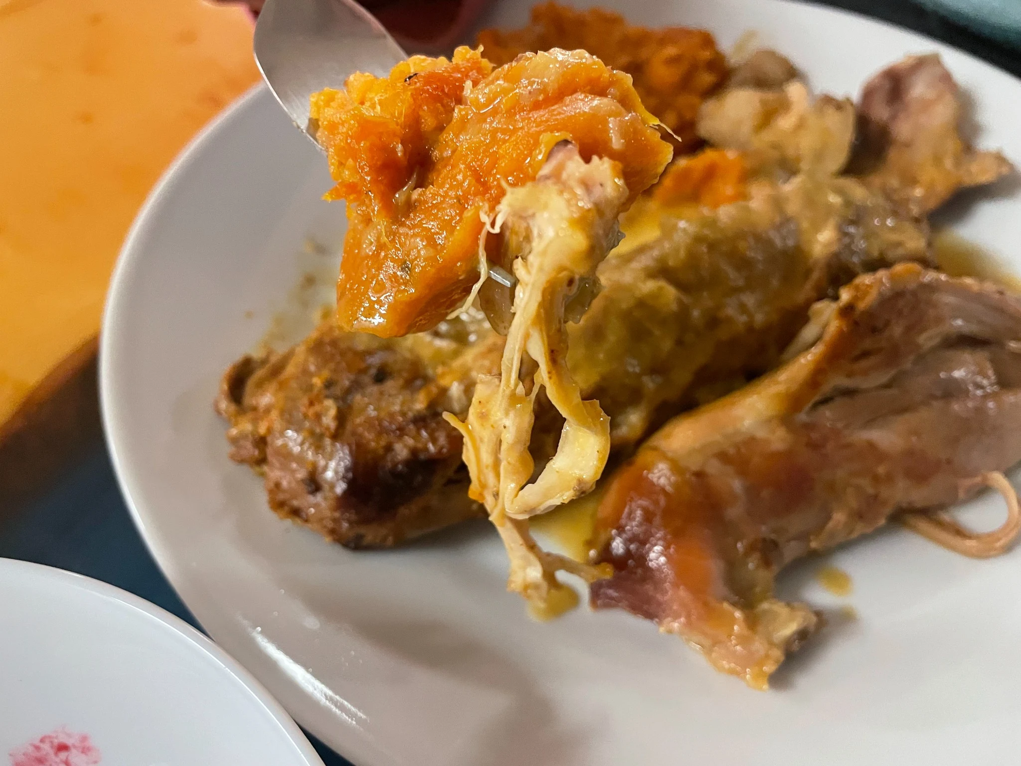 Fork full of sweet potato from a Kat’s Thanksgiving plate with roast turkey and gravy.