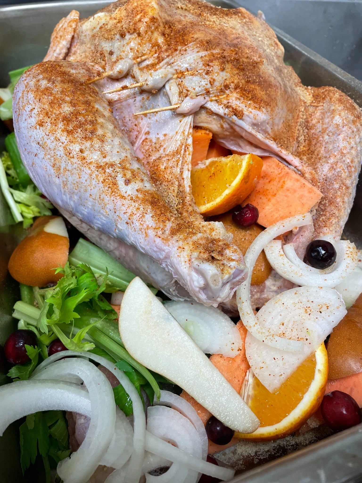 Seasoned Thanksgiving turkey prepared with celery, onions, sweet potatoes, pears, oranges, and cranberries before roasting at Kat’s Café & Restaurant.