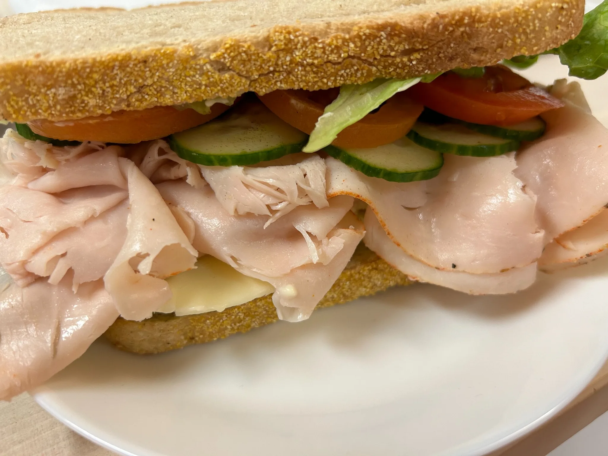 Turkey sandwich on rye bread with cheese, cucumber, tomato, and lettuce at Kat’s Café & Restaurant.