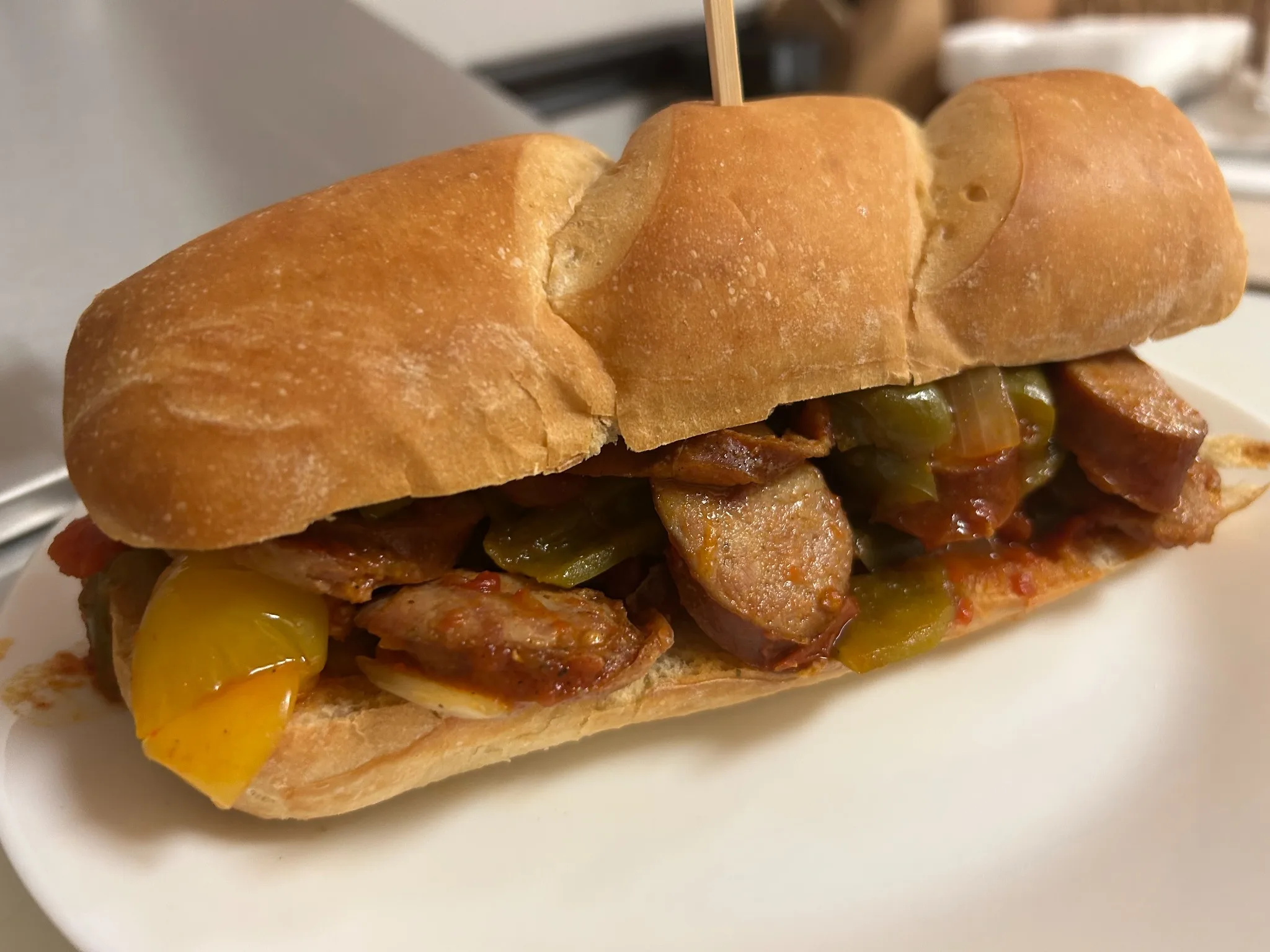 Kielbasa sub with sliced kielbasa, bell peppers, and onions in house tomato letcho sauce on a long hoagie roll at Kat’s Café & Restaurant.