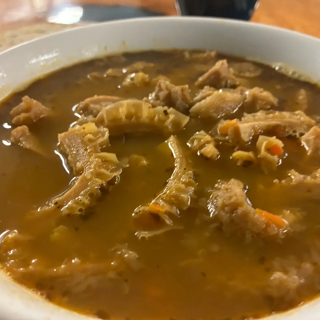 Homemade beef tripe soup at Kat’s Café & Restaurant, with tender pieces of tripe and vegetables in a seasoned brown broth.