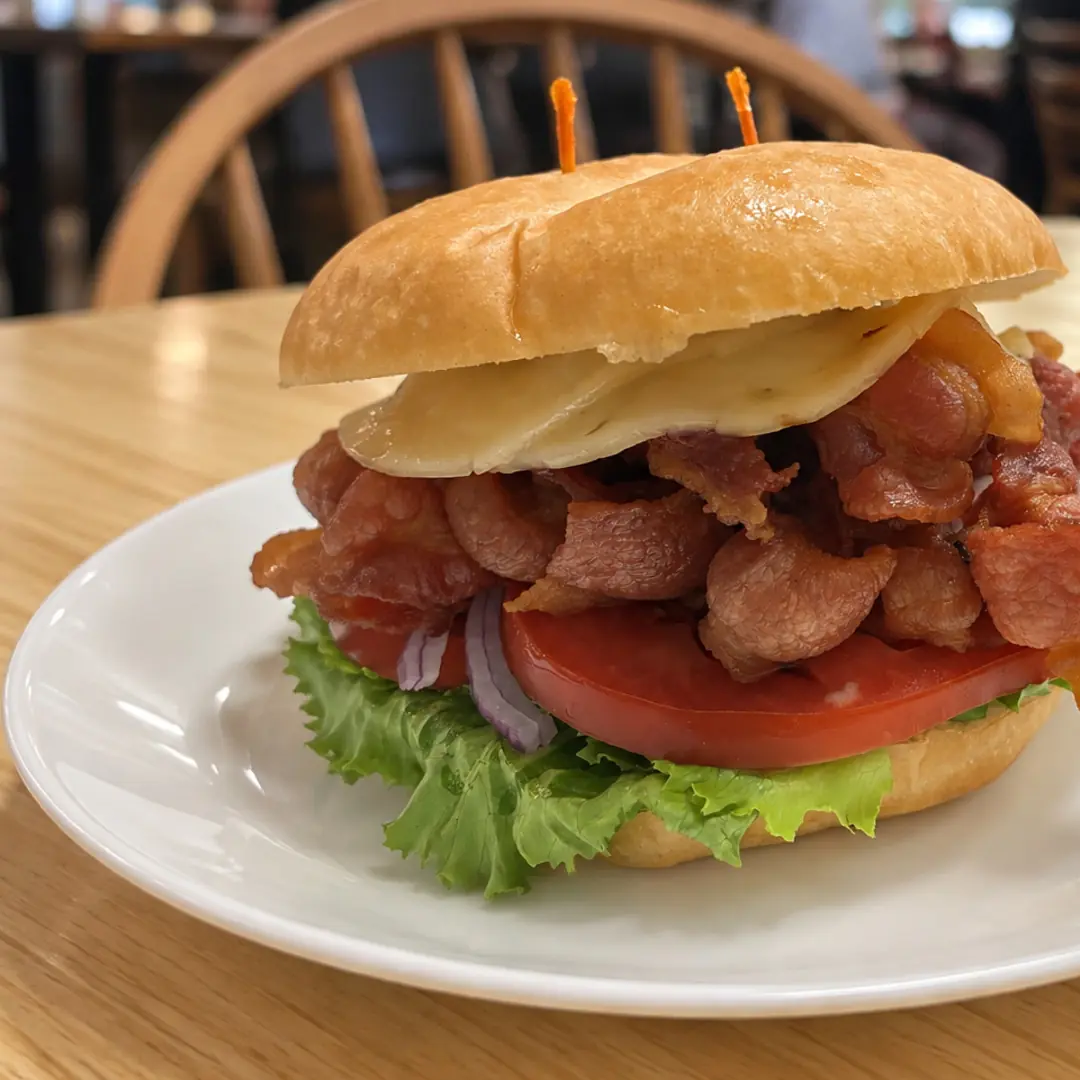 BLT sandwich at Kat’s Café & Restaurant piled with bacon, lettuce, tomato, red onion, and cheese on a fresh roll.