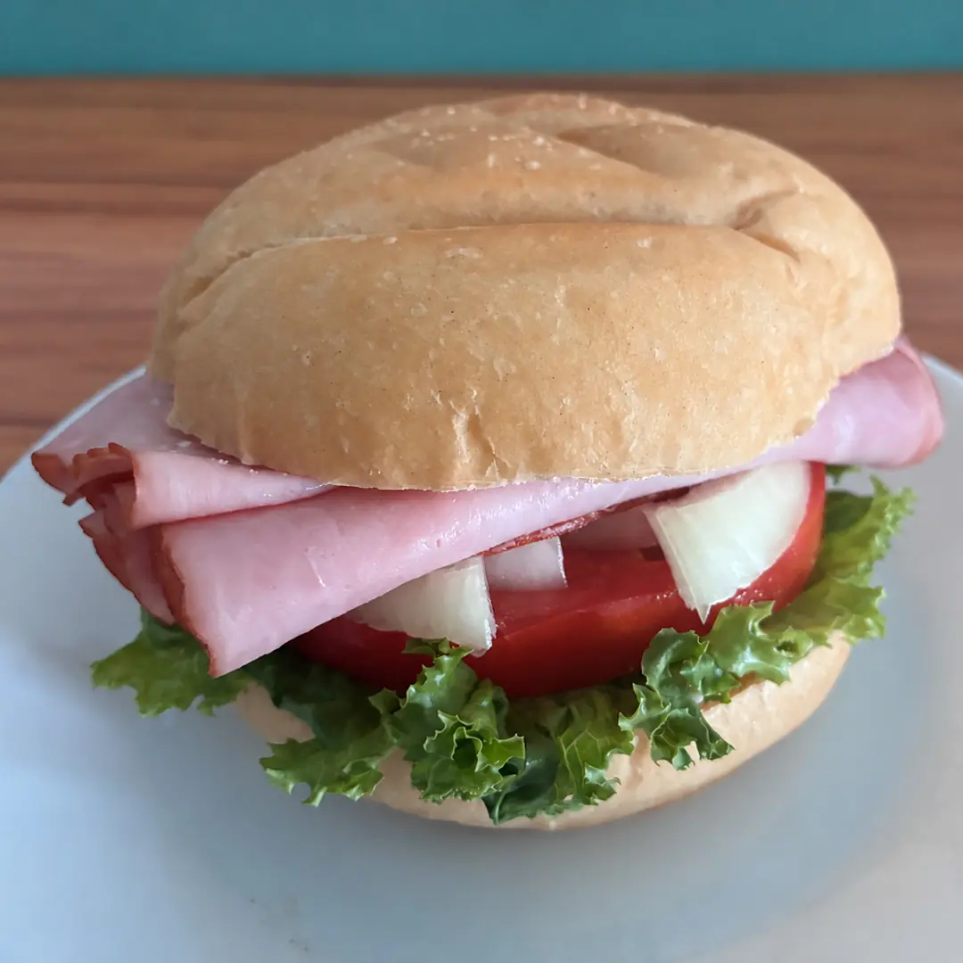 Country ham sandwich at Kat’s Café & Restaurant piled with sliced ham, lettuce, tomato, onion, and mayonnaise on a fresh roll.