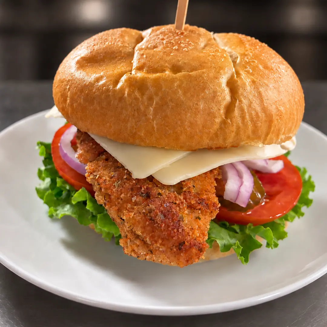 Made-from-scratch at Kat’s Café & Restaurant, hand-breaded chicken cutlet sandwich with lettuce, tomato, red onion, and mayonnaise on a fresh roll.