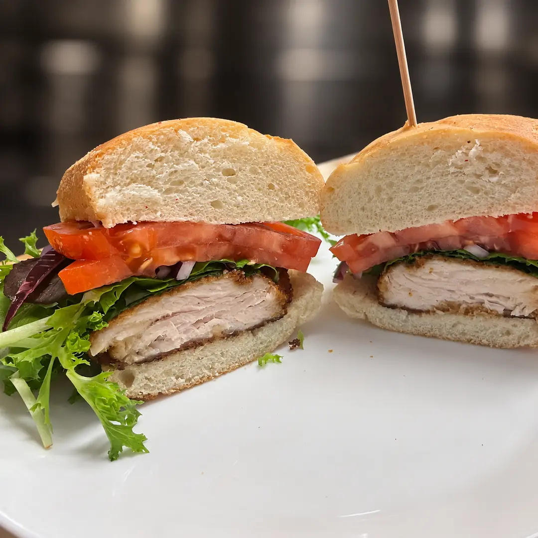 Chicken cutlet sub at Kat’s Café & Restaurant with a hand-breaded chicken cutlet, lettuce, tomatoes, and onions on a fresh roll.