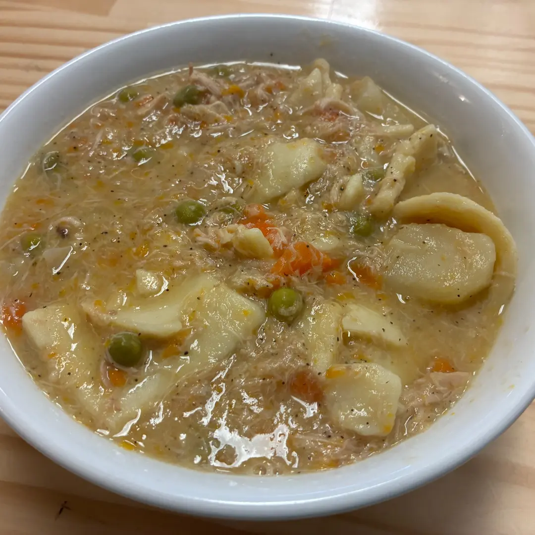 Homemade chicken pot pie soup at Kat’s Café & Restaurant, with tender chicken, vegetables, and soft dough pieces in a creamy broth.