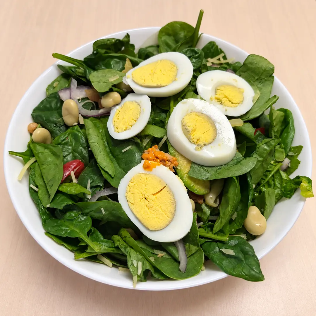 Kat’s Classic Cobb Salad with fresh greens, hard-boiled eggs, bacon, roasted peppers, tomatoes, red onion, cheese, and other fresh ingredients at Kat’s Café & Restaurant.
