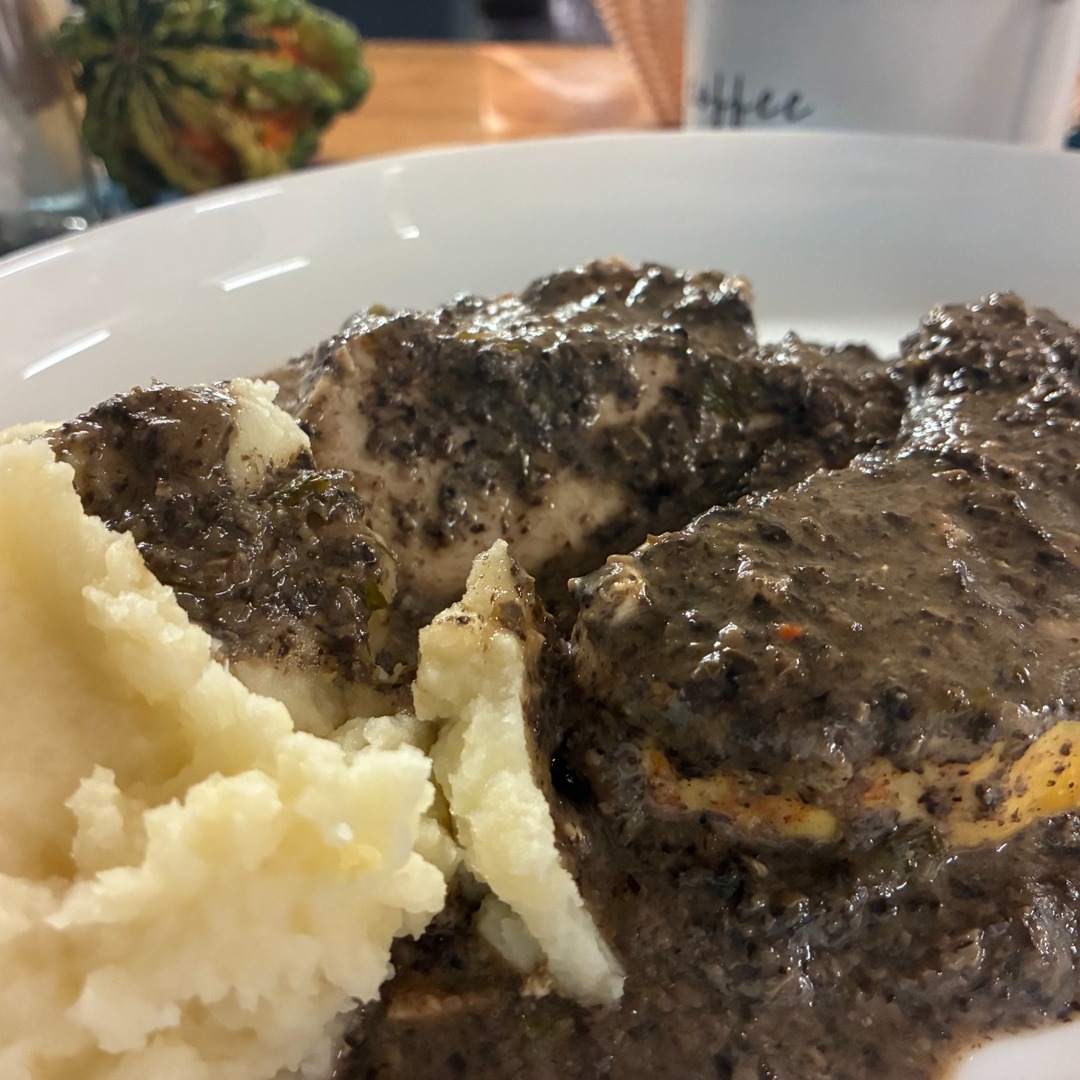 Tender chicken covered in creamy wild mushroom sauce dinner at Kat’s Café & Restaurant served with mashed potatoes and a vegetable side.
