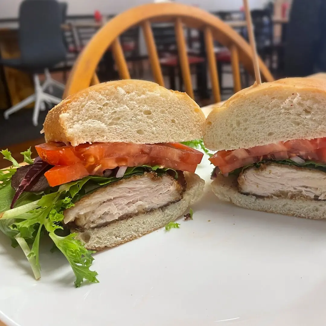 Chicken cutlet sub at Kat’s Café & Restaurant with a hand-breaded chicken cutlet, lettuce, tomatoes, and onions on a fresh roll.
