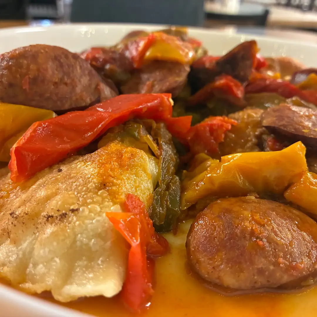 Pan-fried potato-cheese pierogies topped with smoked kielbasa, bell peppers, onions, and tomatoes in letcho sauce at Kat’s Café & Restaurant.