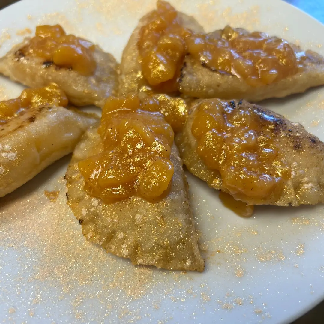 Pan-fried seasonal orchard peach fruit pierogies at Kat’s Café & Restaurant, topped with chunky peach compote.