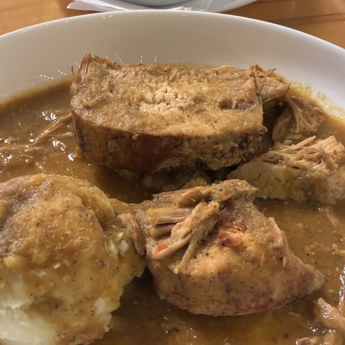 Fork-tender pork roast at Kat’s Café & Restaurant served in a rich homemade gravy made from the vegetables and natural cooking juices alongside a large scoop of mashed potatoes.