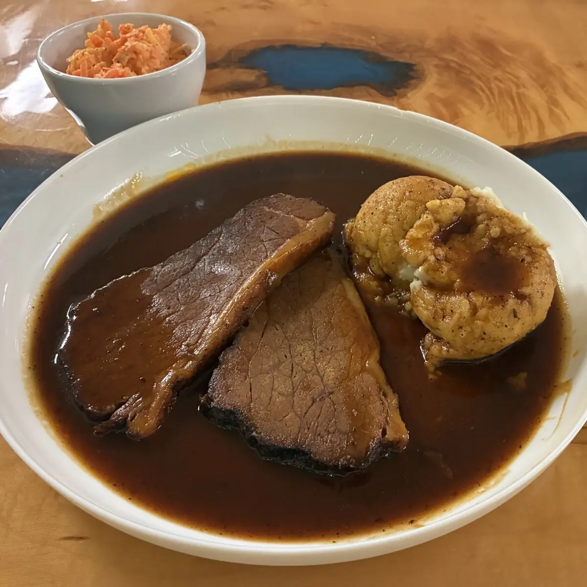 Smoked brisket in homemade BBQ sauce with mashed potatoes and Slavic vegetable salad at Kat’s Café & Restaurant.