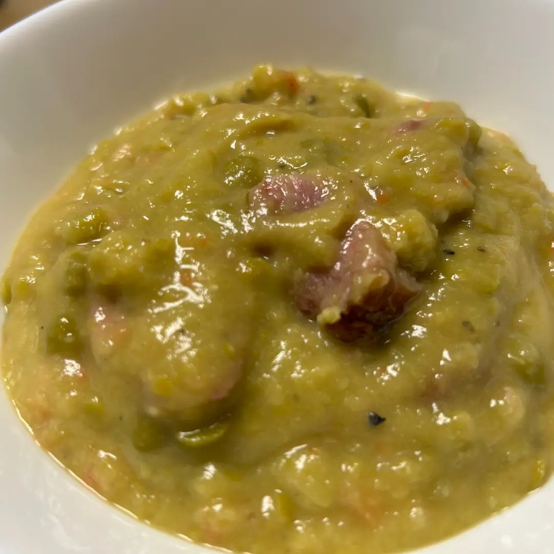 Creamy split pea soup at Kat’s Café & Restaurant, with tender pieces of ham in a white bowl.