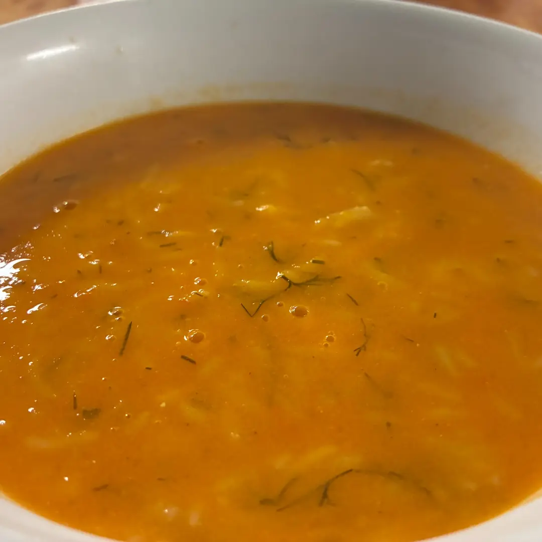 Homemade creamy tomato soup at Kat’s Café & Restaurant, with fresh tomatoes and herbs served in a white bowl.