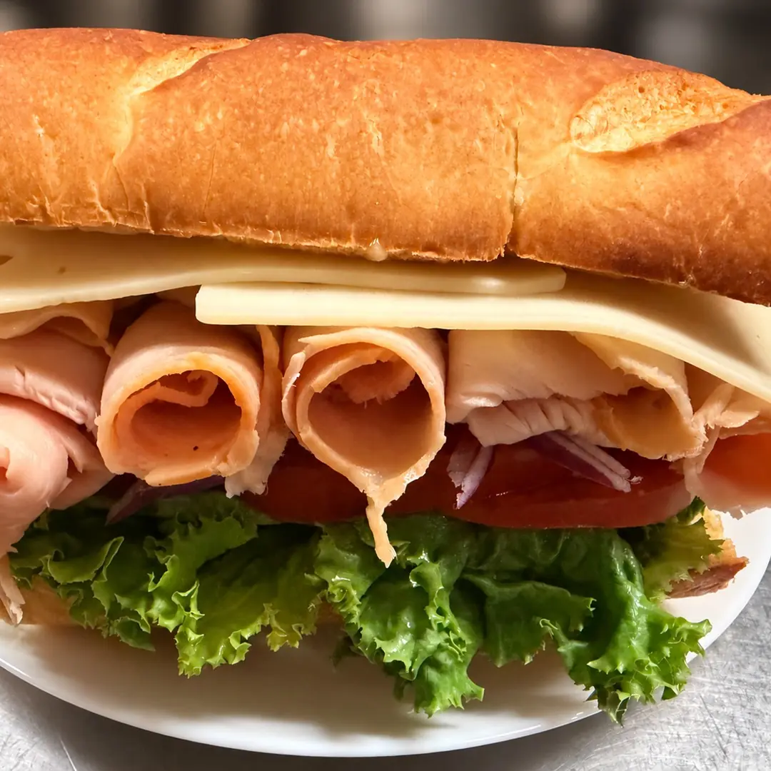 Turkey sub at Kat’s Café & Restaurant shown with sliced turkey, cheese, lettuce, tomato, and onion on a fresh hoagie roll.