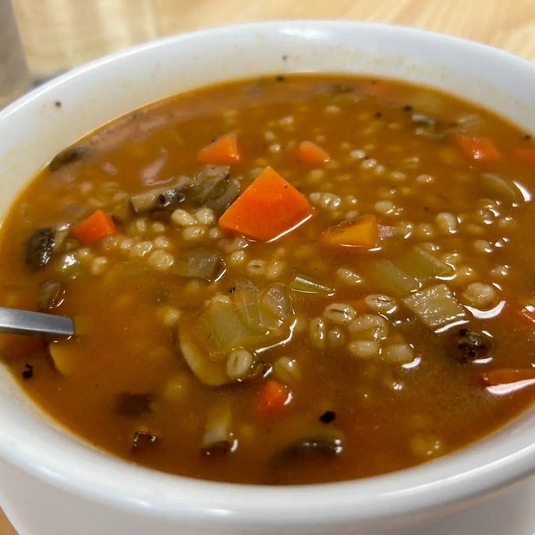 Homemade mushroom barley soup at Kat’s Café & Restaurant, with tender mushrooms, barley, carrots, celery, and onions in a savory broth.